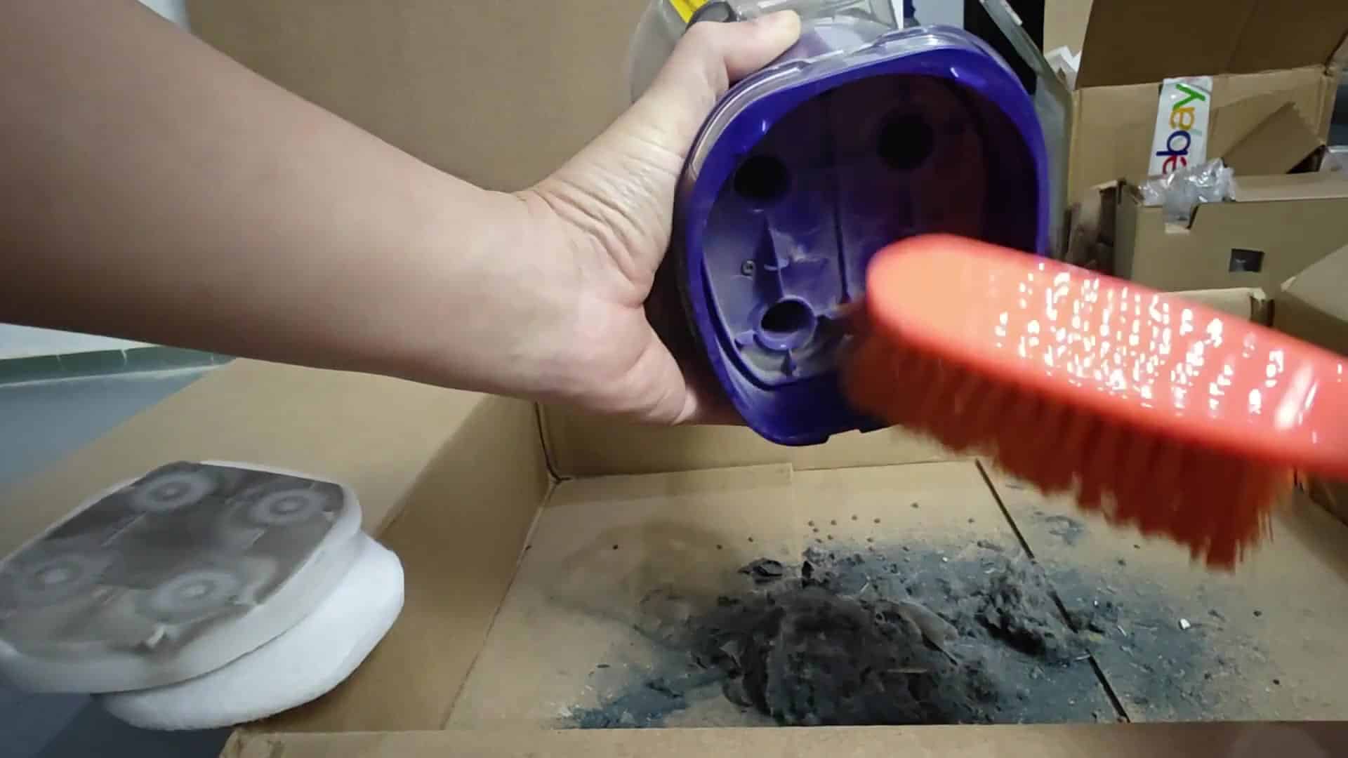 Brushing dust off a filter pad Brushing dust off a filter pad