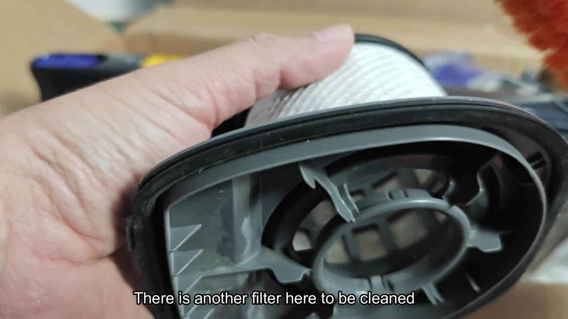 Brushing white mesh filter with orange brush Brushing white mesh filter with orange brush
