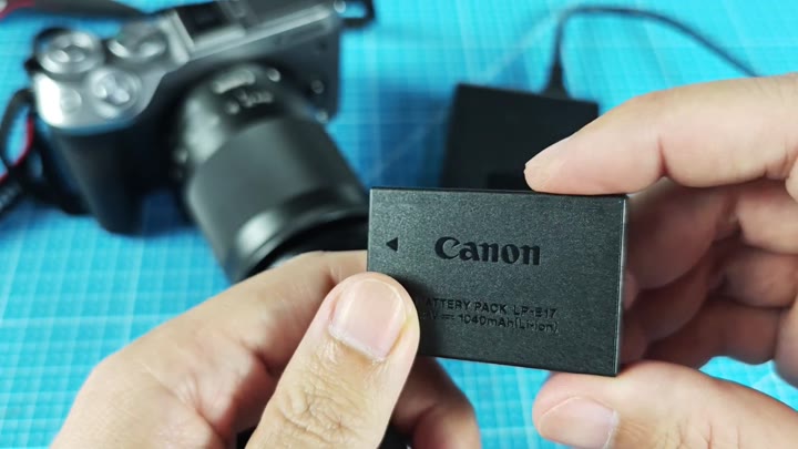 Canon LP-E17 battery on blue mat Canon LP-E17 battery on blue mat