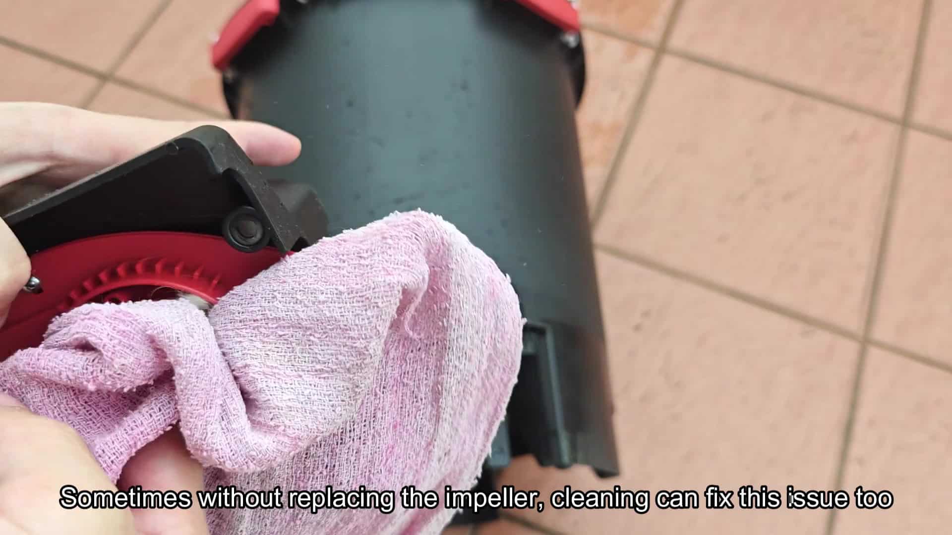 Cleaning impeller area with a cloth Cleaning impeller area with a cloth