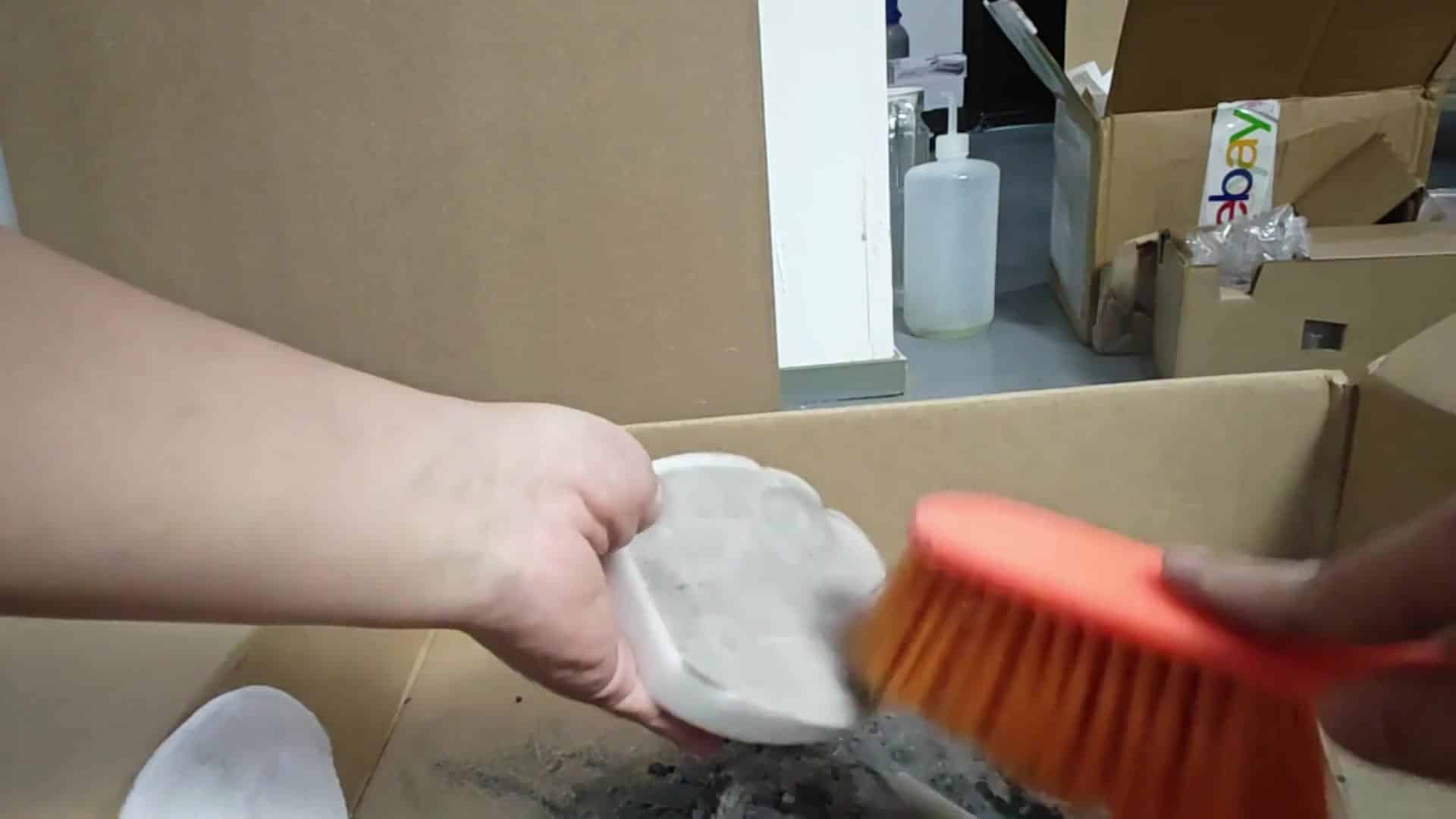 Dirty foam filter pad being brushed Dirty foam filter pad being brushed