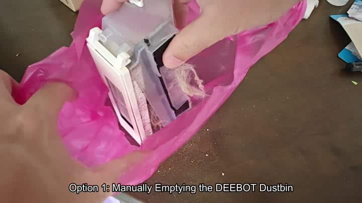 Dumping hair and debris into pink bag Dumping hair and debris into pink bag