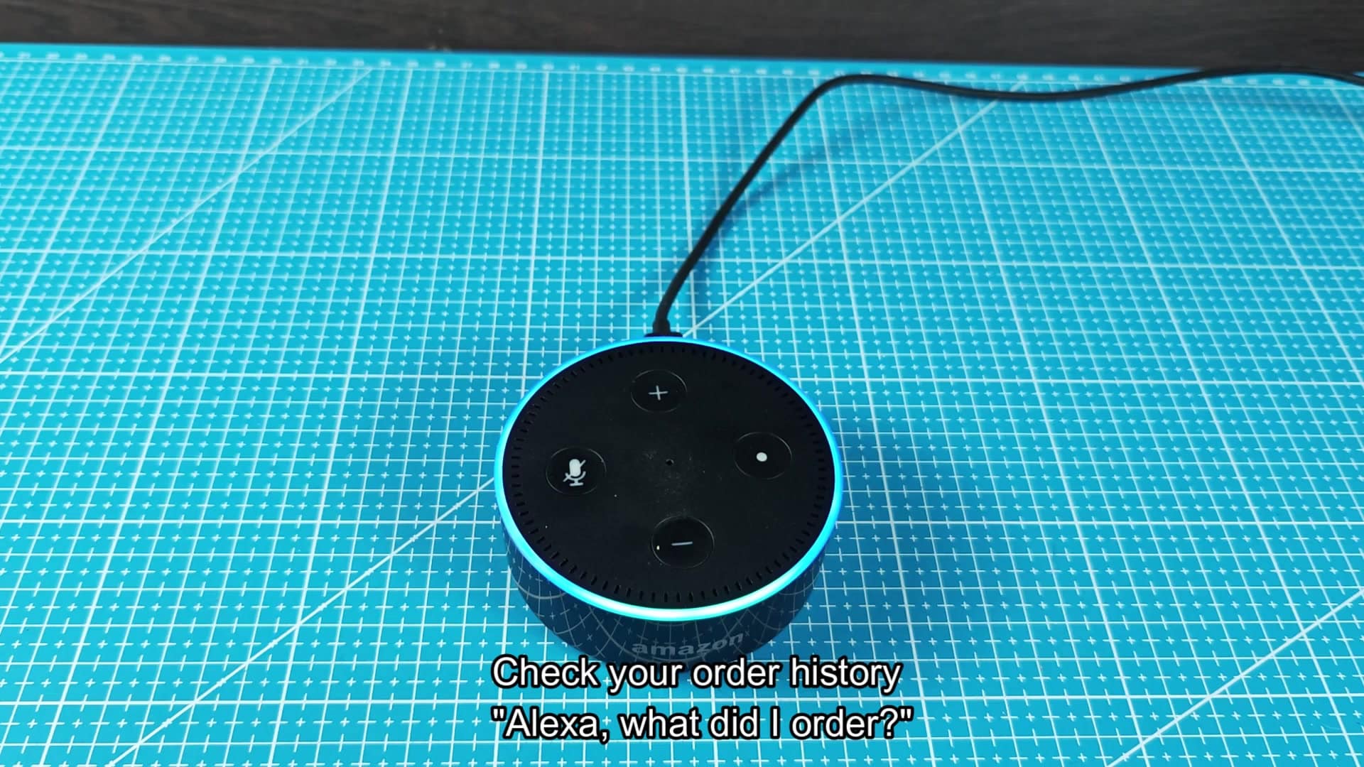 Echo Dot with blue light ring lit Echo Dot with blue light ring lit