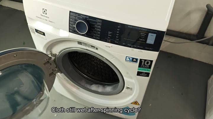 Electrolux washer with wet clothes inside Electrolux washer with wet clothes inside