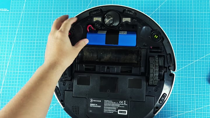Exposed blue battery pack inside vacuum Exposed blue battery pack inside vacuum