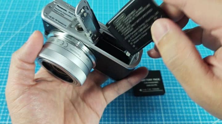 Inserting battery into Lumix camera Inserting battery into Lumix camera