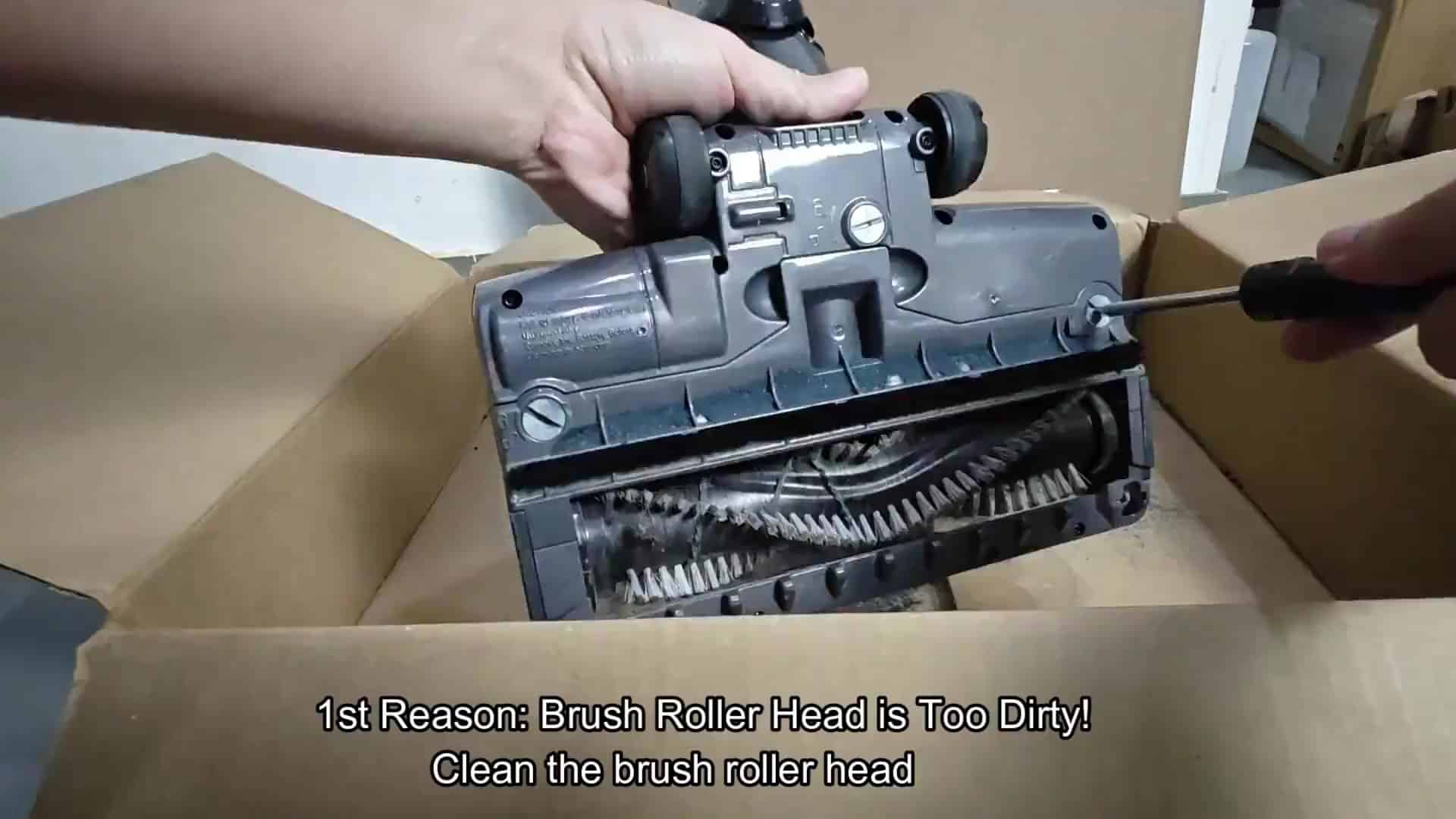 Inspecting dirty brush roller for debris Inspecting dirty brush roller for debris