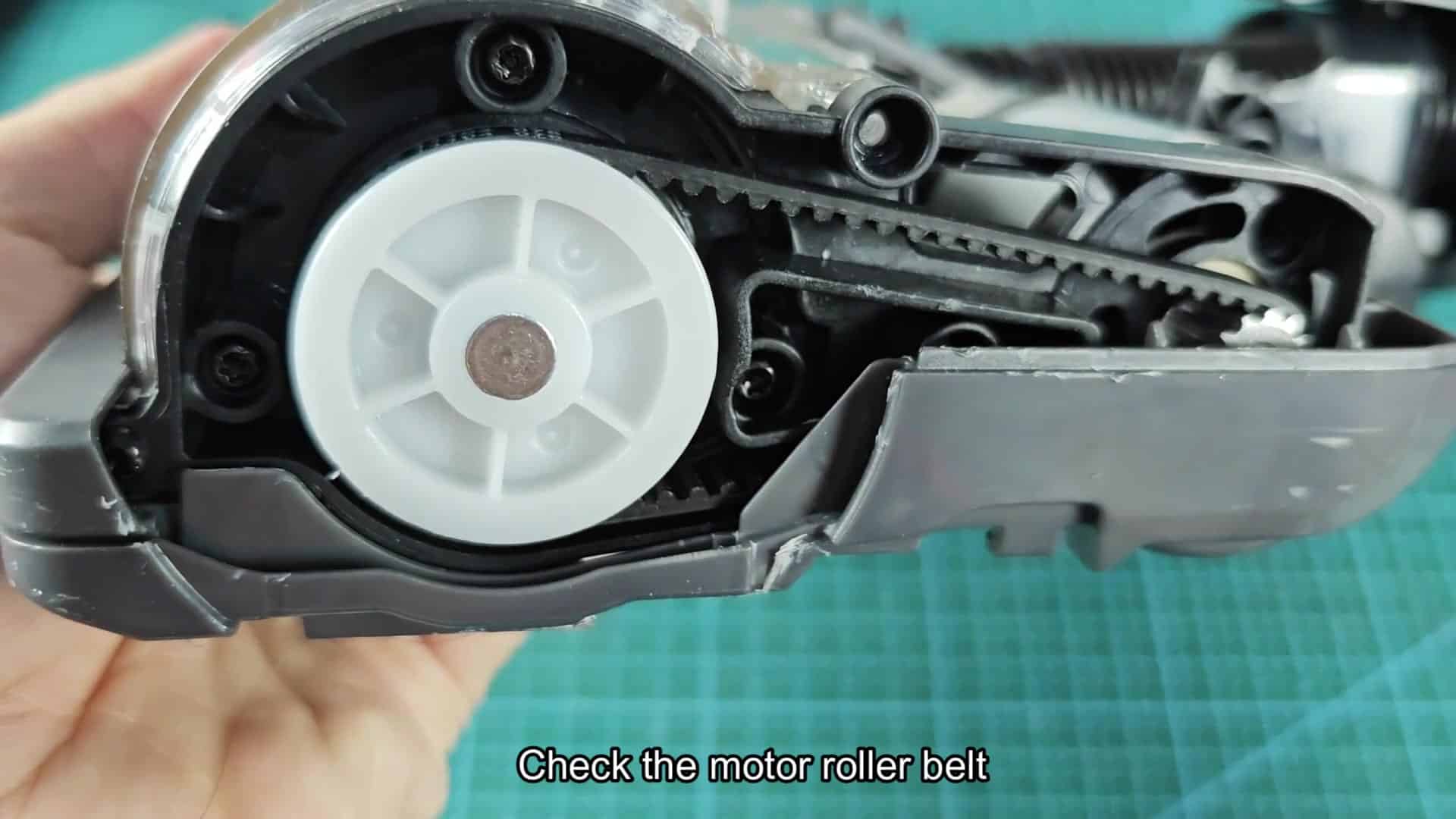 Inspecting the motor roller belt inside Inspecting the motor roller belt inside