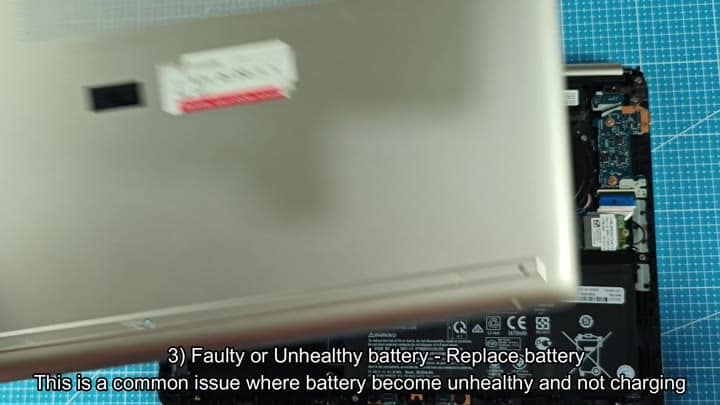 Open laptop revealing internal battery components Open laptop revealing internal battery components