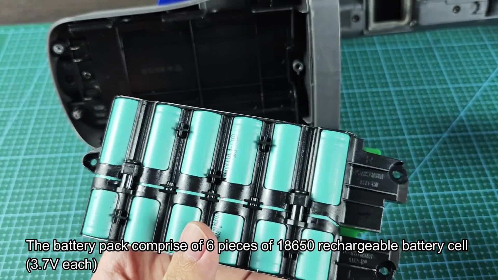 Opened battery pack showing turquoise cells Opened battery pack showing turquoise cells
