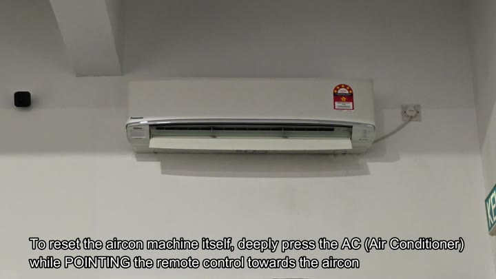 Pointing remote at wall mounted aircon Pointing remote at wall mounted aircon