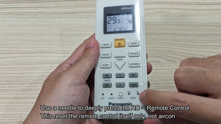 Pressing remote reset button with needle Pressing remote reset button with needle