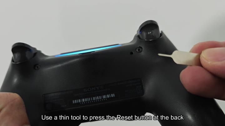 Pressing reset button with thin plastic tool Pressing reset button with thin plastic tool