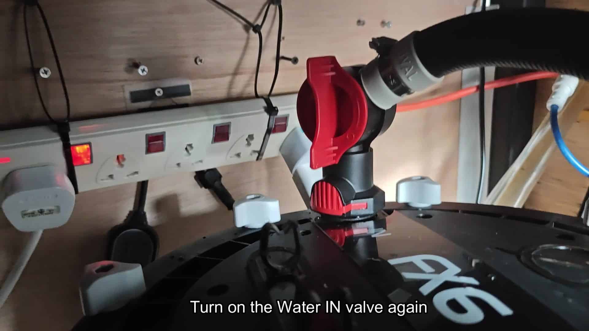 Red valve handle turned open position Red valve handle turned open position
