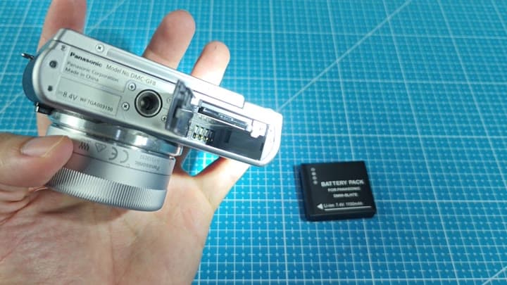 Replacement battery next to open camera Replacement battery next to open camera