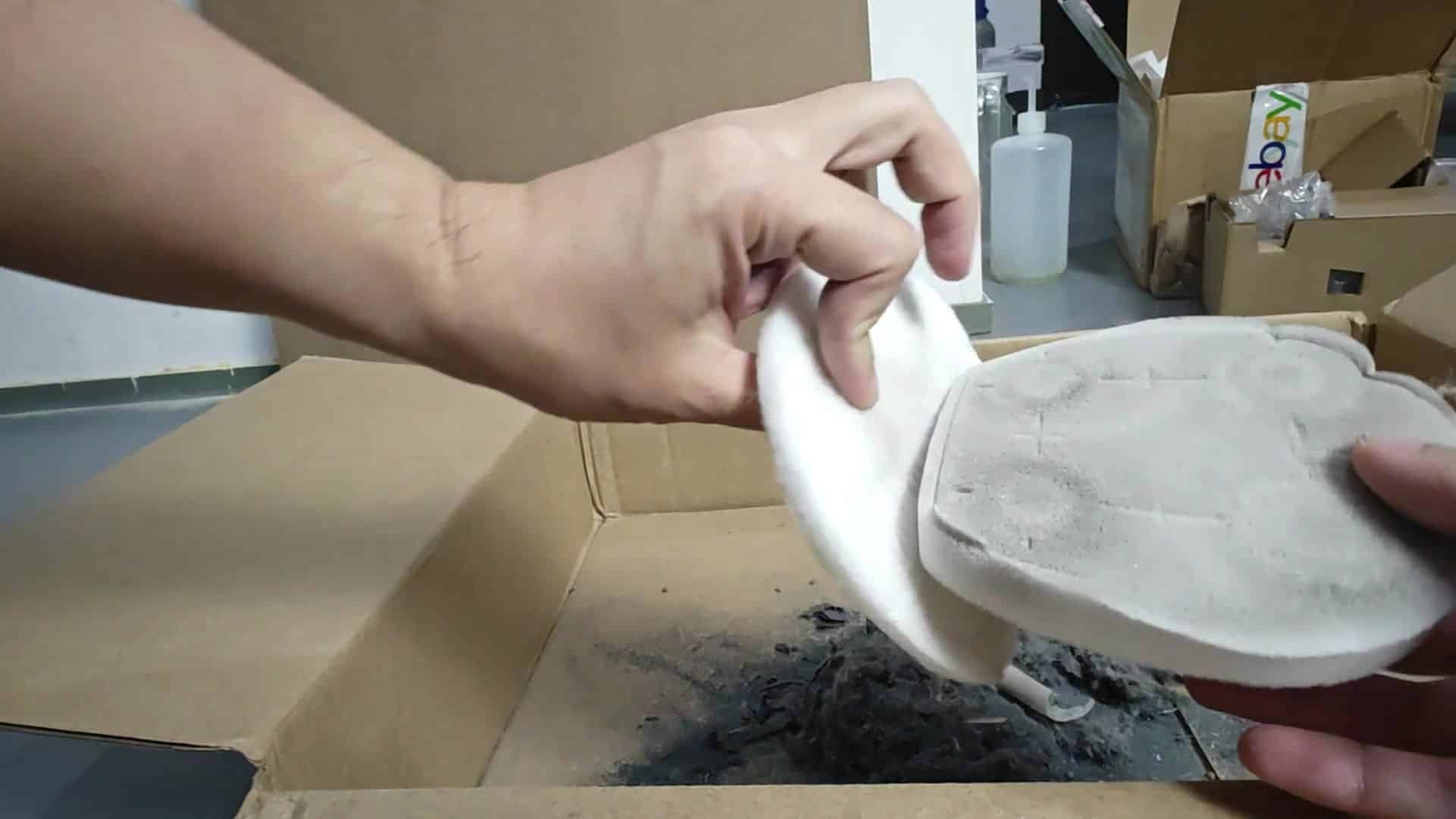 Rinsing filter pad in running sink water Rinsing filter pad in running sink water
