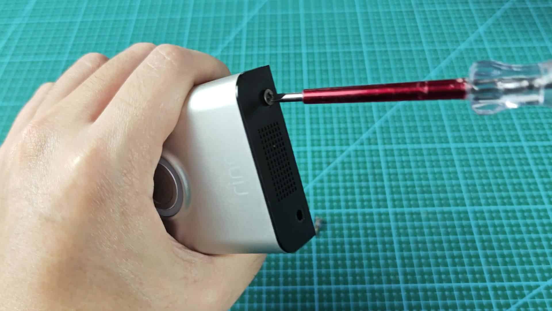 Screwdriver turning upper panel screw Screwdriver turning upper panel screw