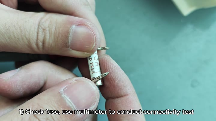 Testing fuse with multimeter probe Testing fuse with multimeter probe