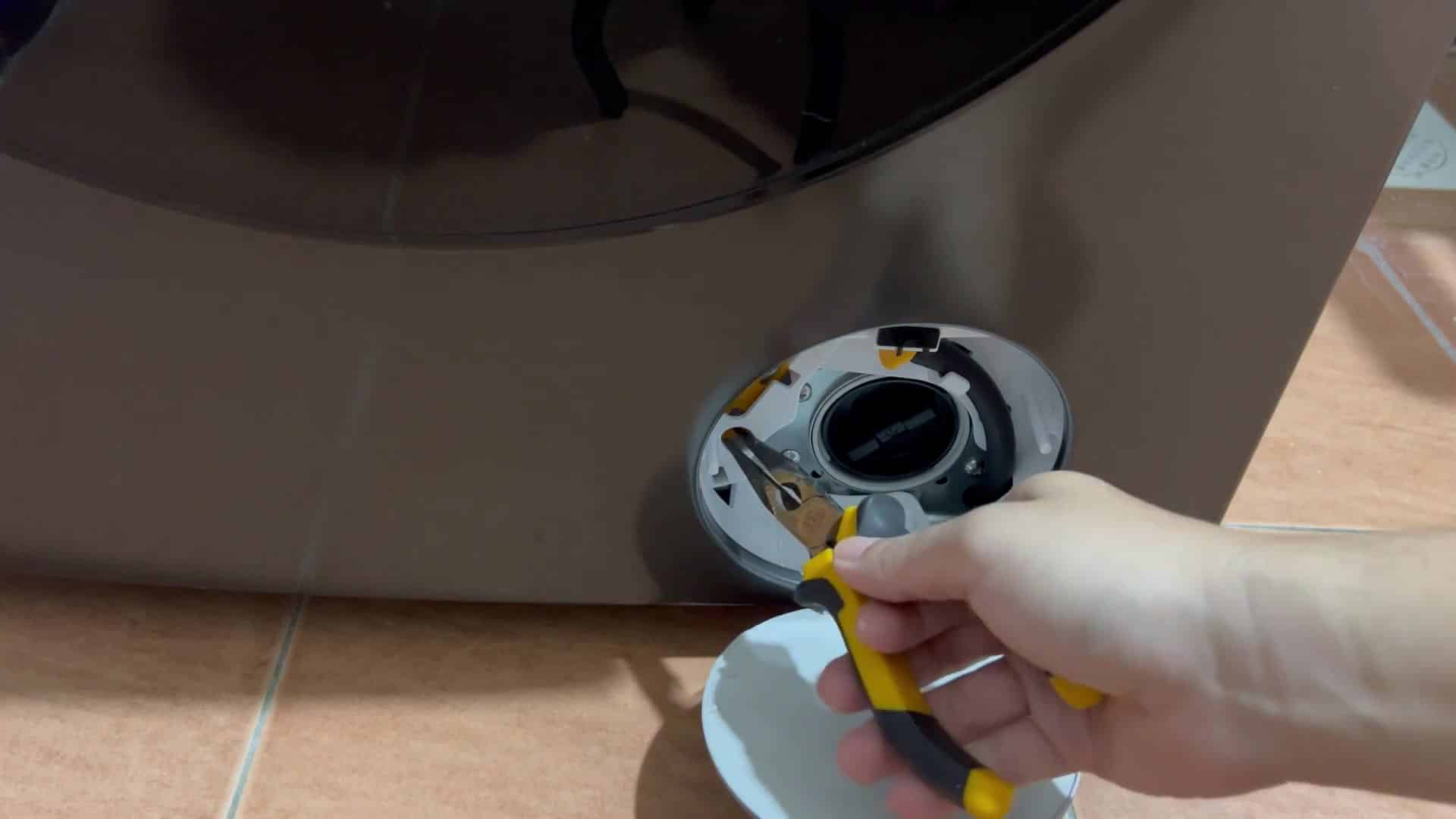 Using pliers to pull release strap Using pliers to pull release strap
