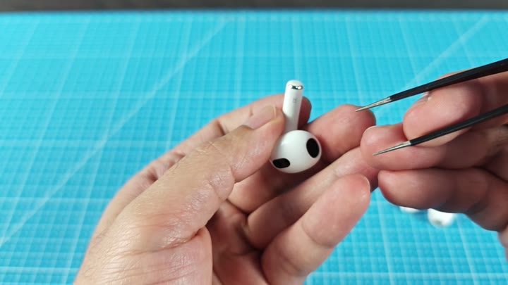 Using tweezers on earbud surface Using tweezers on earbud surface