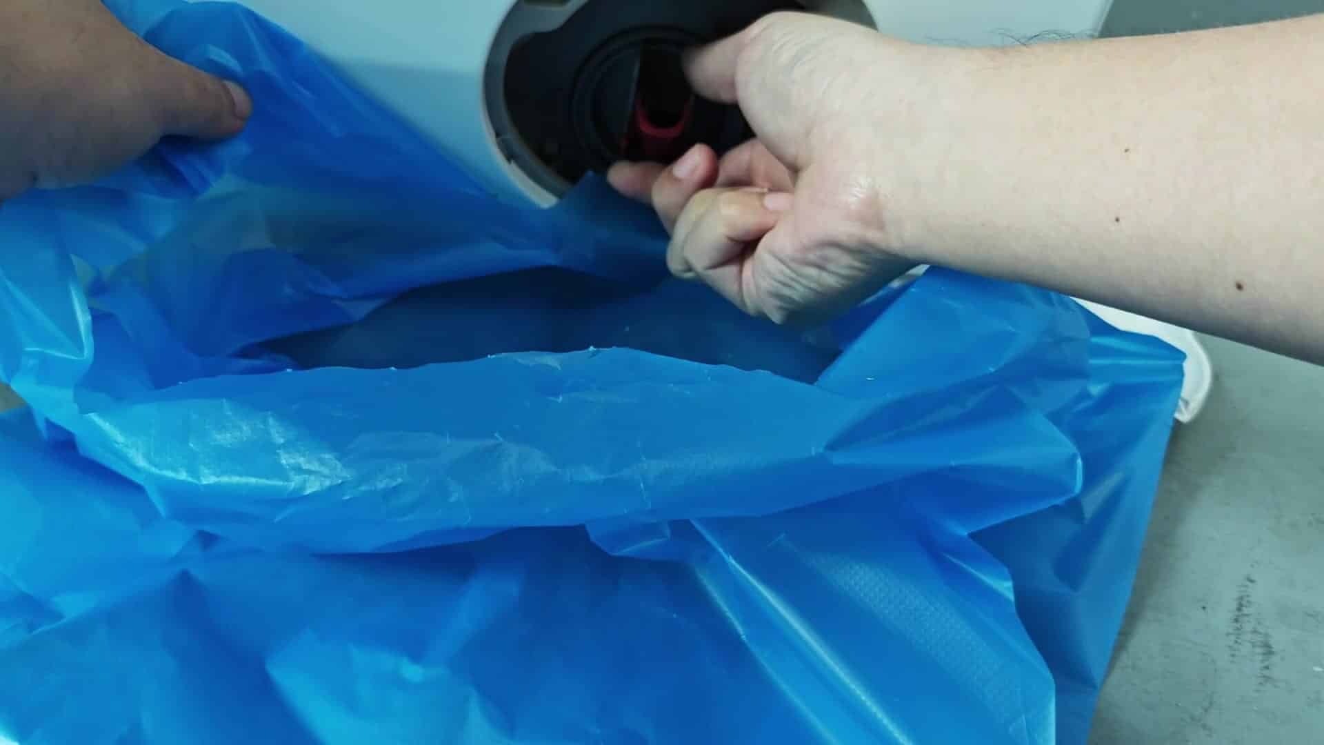 Water draining into blue plastic bag Water draining into blue plastic bag