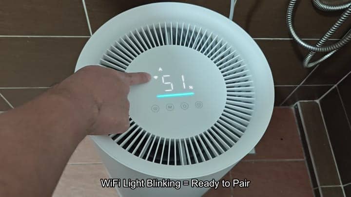 White dehumidifier shows WiFi pairing ready White dehumidifier shows WiFi pairing ready