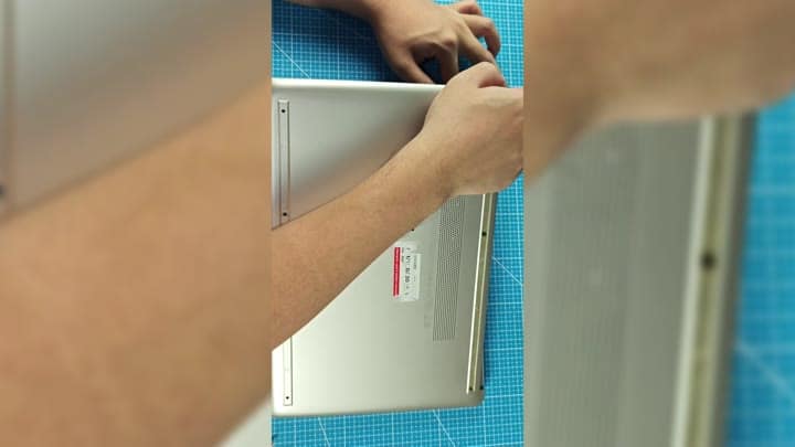 Adjusting silver laptop back component Adjusting silver laptop back component