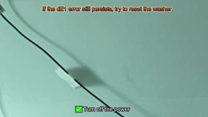 Black power cord on white appliance surface Black power cord on white appliance surface