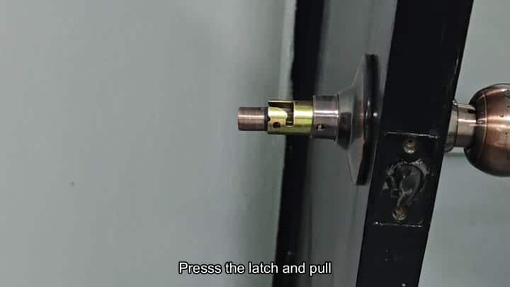 Brass latch bolt extended into frame Brass latch bolt extended into frame