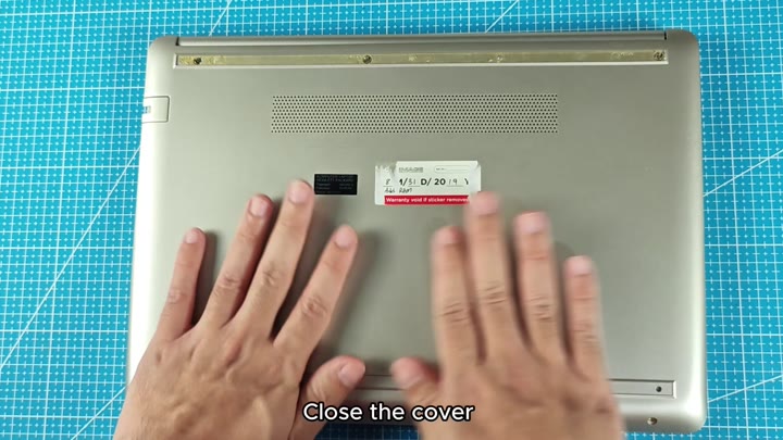 Closed laptop back showing warranty void sticker Closed laptop back showing warranty void sticker