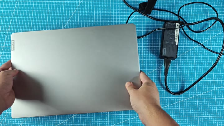 Closed Lenovo laptop on blue mat Closed Lenovo laptop on blue mat