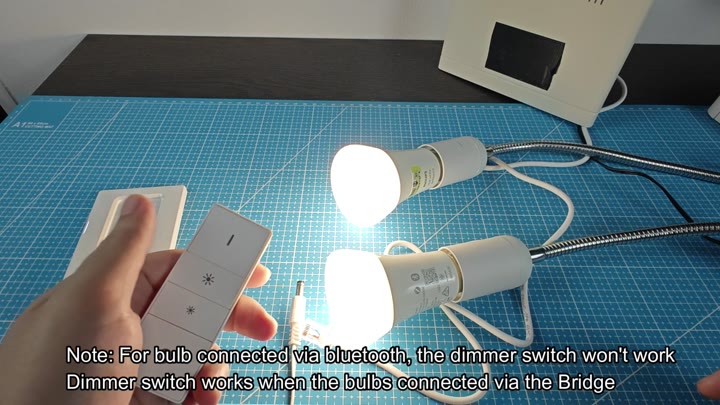Dimmer switch shown next to lit bulbs Dimmer switch shown next to lit bulbs