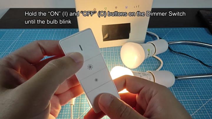 Holding dimmer buttons to reset bulb Holding dimmer buttons to reset bulb