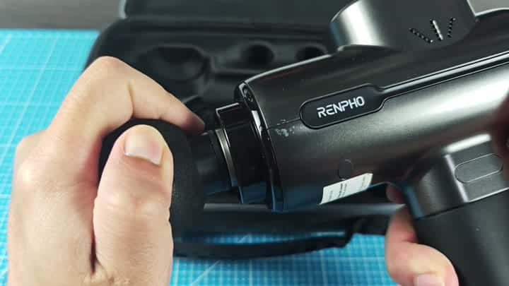 Holding RENPHO massage gun over case Holding RENPHO massage gun over case