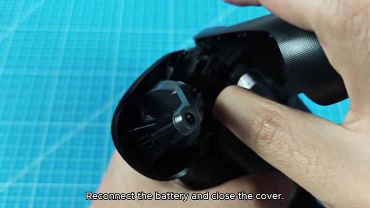 Inserting battery into open controller Inserting battery into open controller