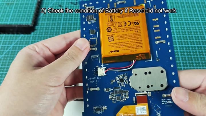 Orange battery on blue circuit board Orange battery on blue circuit board