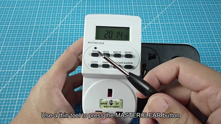 Pressing MASTERCLEAR button with thin tool Pressing MASTERCLEAR button with thin tool