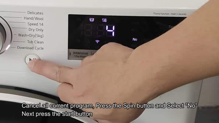 Pressing start button on white washer Pressing start button on white washer