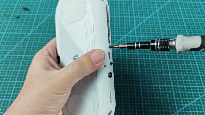 Removing screw from handheld console Removing screw from handheld console