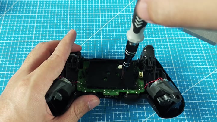 Screwdriver working on controller circuit board Screwdriver working on controller circuit board