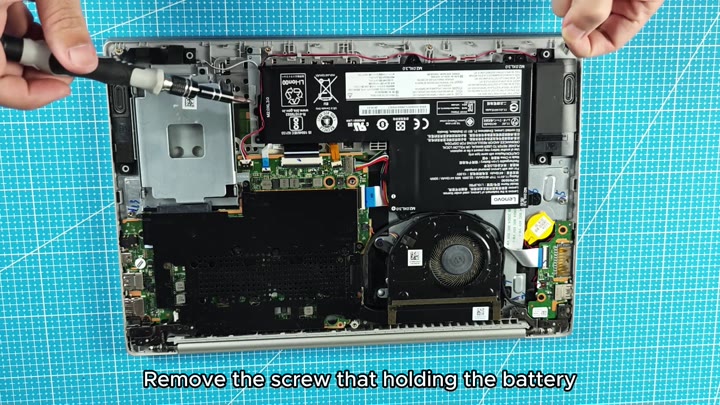 Unscrewing battery screw with screwdriver Unscrewing battery screw with screwdriver