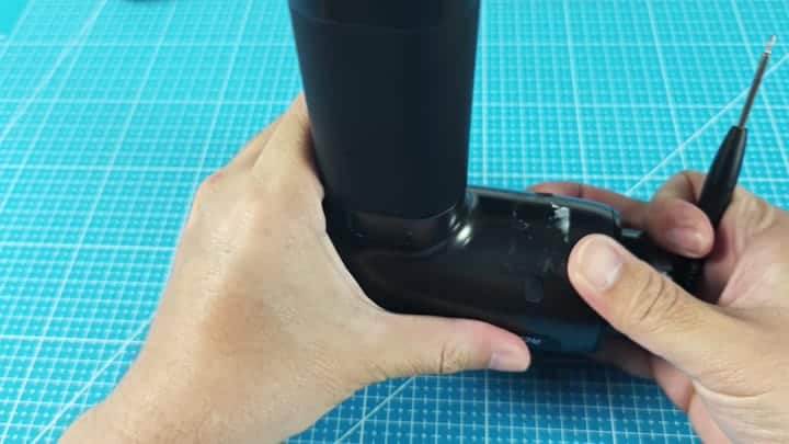 Using screwdriver on black device Using screwdriver on black device
