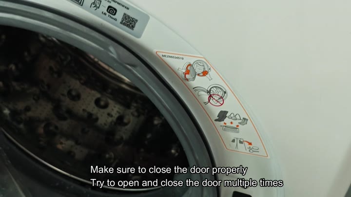 Washing machine drum interior with safety sticker Washing machine drum interior with safety sticker
